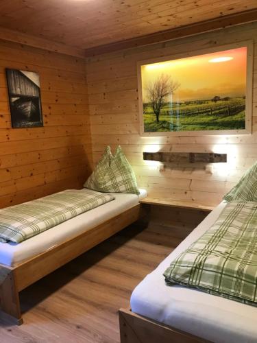 a room with two beds in a wooden cabin at Apartment Eisenhut - EBE500 by Interhome in Hüttau