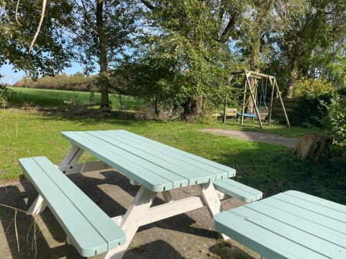 a picnic table and a swing set in a park at Holiday Home De Dars by Interhome in Stolpen