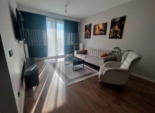 a living room with a couch and a television at luxury family 2+1 apt in toya next Residence in Istanbul