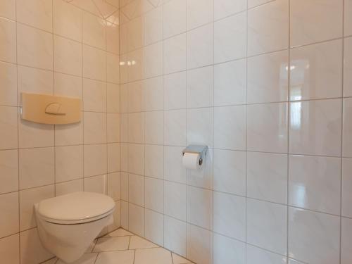 a bathroom with a toilet and a toilet paper dispenser at Apartment Voithofer-7 by Interhome in Königsleiten