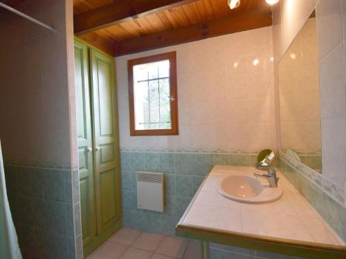 a bathroom with a sink and a window at Holiday Home Au Cayroux by Interhome in Blanquefort-sur-Briolance
