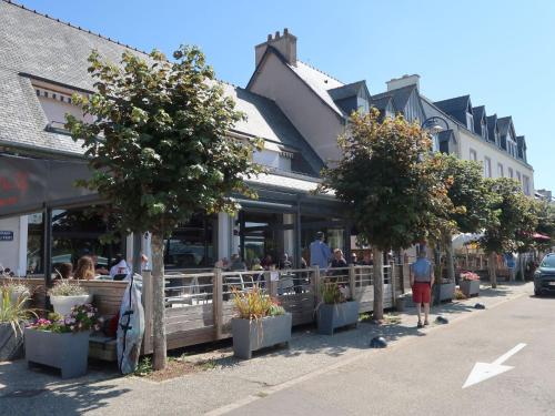 a group of people walking in front of a restaurant at Chalet L'Atelier by Interhome in Locquirec