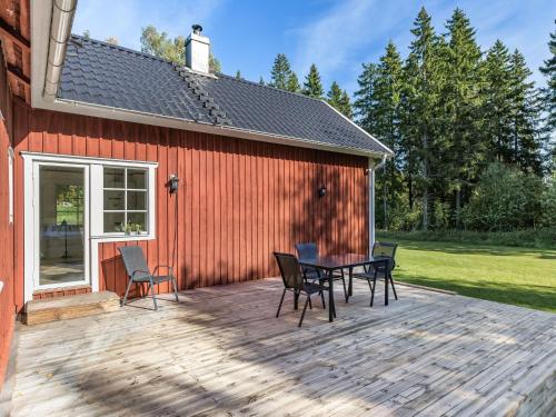 a patio with chairs and a table next to a building at Holiday Home Aspenäs by Interhome in Falköping