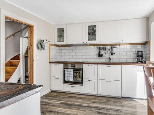 a kitchen with white cabinets and an oven at Holiday Home Aspenäs by Interhome in Falköping