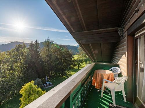 a balcony with a table and chairs on a house at Apartment Alpenrose-3 by Interhome 