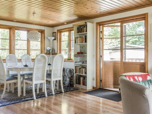 a dining room with a table and chairs at Holiday Home Kjuge Nya Huset by Interhome in Fjälkinge