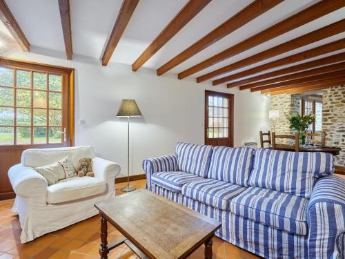 a living room with a couch and a table at Holiday Home La Voisinière no-1 by Interhome in Savigny