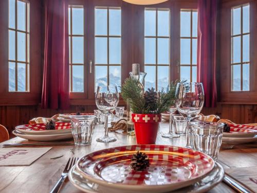 a table with christmas plates and glasses on it at Chalet Bivak by Interhome in Nendaz