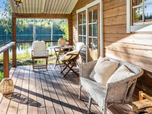 a screened in porch with chairs and a table at Holiday Home Niemenkärki by Interhome in Kortteinen