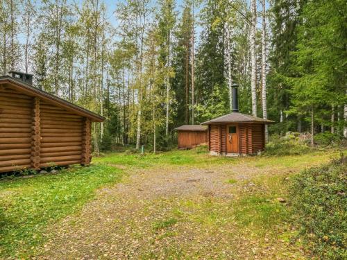 a cabin and a small building in the woods at Holiday Home Pyöriäinen by Interhome in Pääskynniemi