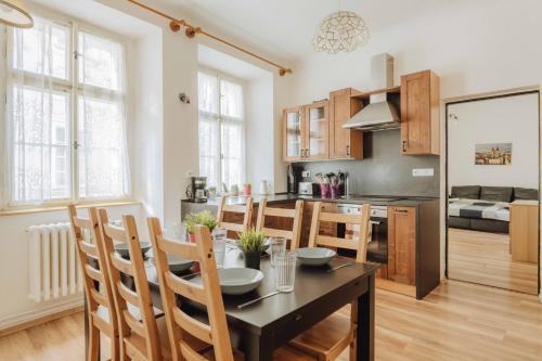a kitchen and dining room with a table and chairs at Central 3BD Apartment Old Town Square & Astronomical Clock 100 metres in Prague