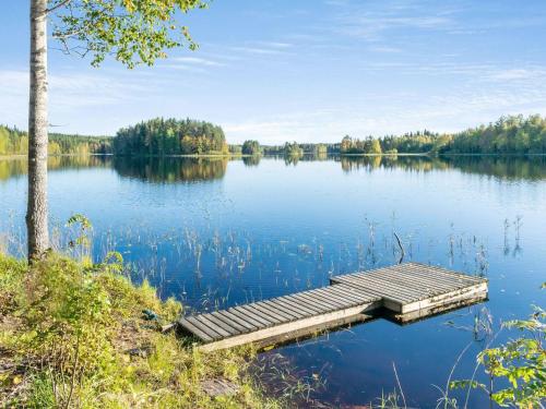 a dock in the middle of a lake at Holiday Home Lahdenpohja by Interhome in Kortteinen