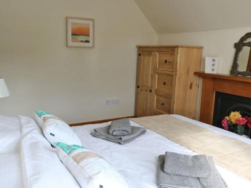 a bedroom with a bed with towels on it at Holiday Home Dunan by Interhome in Dunan