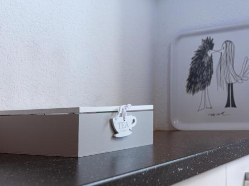 a small white box with a key on a counter at Apartment Clair Matin 20 by Interhome in Nendaz