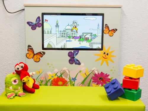 a green table with toys and butterflies on it at Apartment Falkner-13 by Interhome in Oberlängenfeld