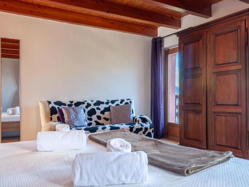 a bedroom with a bed with two towels on it at Holiday Home Le Dahu by Interhome in Nendaz