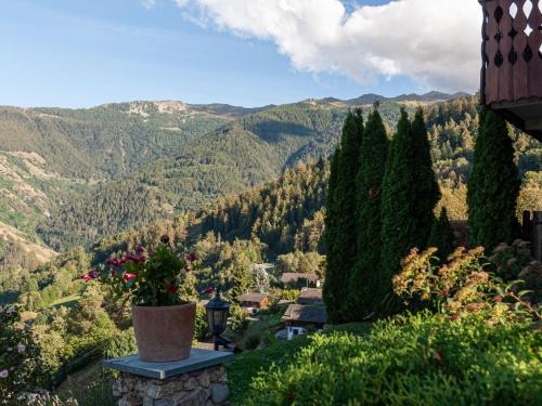 a vase on a stone ledge overlooking a valley at Holiday Home Le Dahu by Interhome in Nendaz