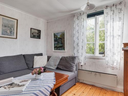 a living room with a couch and a table at Chalet Kasen Lillstugan by Interhome in Färgelanda