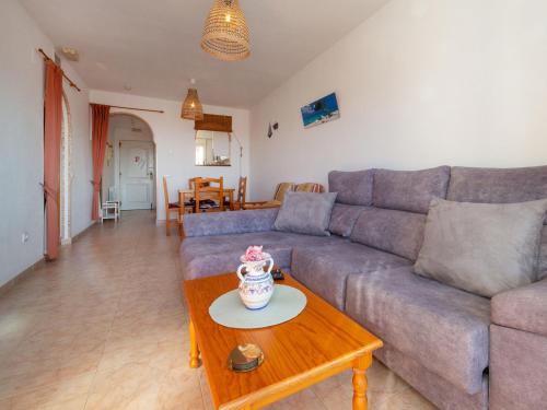 een woonkamer met een bank en een salontafel bij Apartment Garduix by Interhome in Calpe