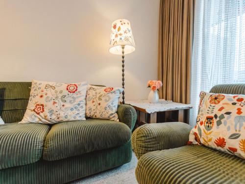 a living room with a couch and a chair at Apartment Sonnenappartements by Interhome in Bad Hofgastein