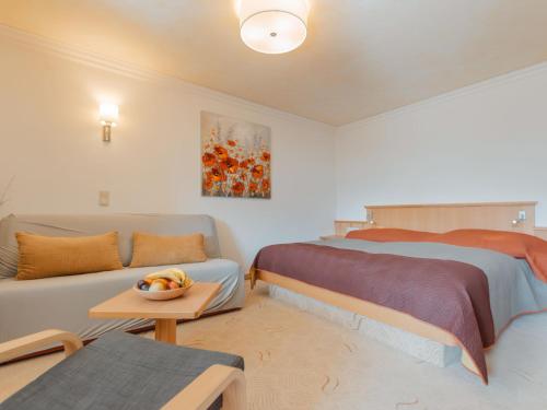 una camera da letto con un letto, un divano e un tavolo di Apartment Rose by Interhome a Bad Hofgastein