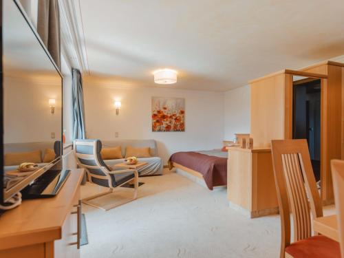 a hotel room with a bed and a couch at Apartment Rose by Interhome in Bad Hofgastein