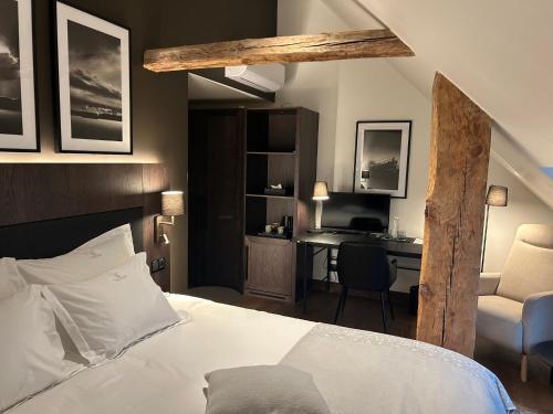 a bedroom with a bed and a desk and a chair at Padise Manor in Padise