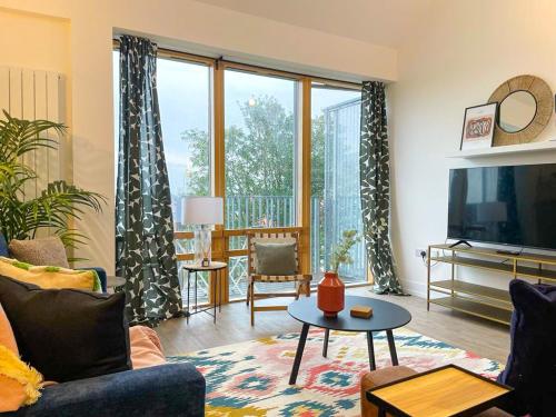 a living room with a couch and a tv at Coventry Large 4-bed Townhouse by Empower Homes in Coventry