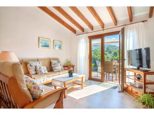 a living room with a couch and a tv at Apartment S'Atalaia Sea Views by Interhome in Port de Soller