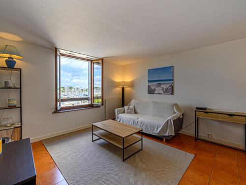 a living room with a couch and a coffee table at Apartment Le Quai by Interhome in La Trinité-sur-Mer