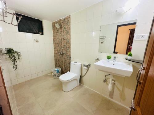 a bathroom with a toilet and a sink at GR Stays - Duplex 3bhk Villa With Pool Arpora I Baga Beach 5 mins in Arpora