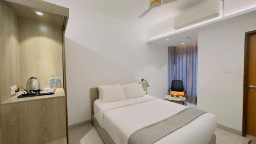 a hotel room with a bed and a window at Priyo Nibash Stylish Residential Hotel in Dhaka