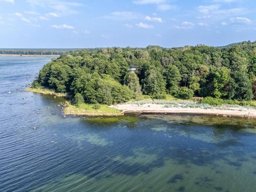 an island in the middle of a body of water at Chic Sauna Cabin Near the Sea - KOHIN Cabin Nº02 in Tsitre