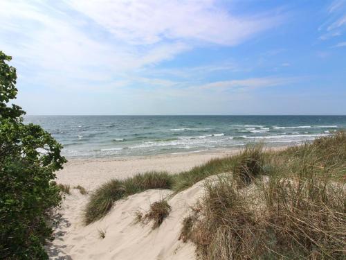a sandy beach with the ocean in the background at Holiday Home Kolle - 3-2km from the sea in Bornholm by Interhome in Vester Sømarken
