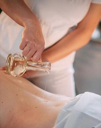 a woman is washing her buttocks with a bottle of water at Peterc Vineyard Estate in Kojsko