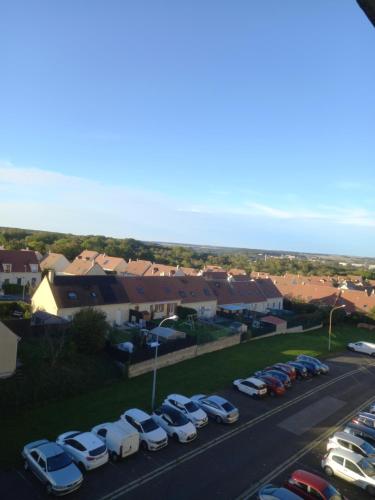 a group of cars parked in a parking lot at Spacieux appartement 4 pieces in Beauvais