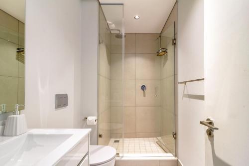 a bathroom with a shower and a toilet and a sink at AlimamaSpaces The Moksit Suite Ellipse in Midrand