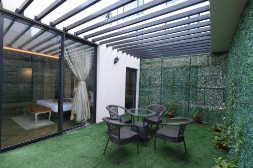 a patio with a table and chairs and a tub at Hotel Polo Towers Agartala in Agartala