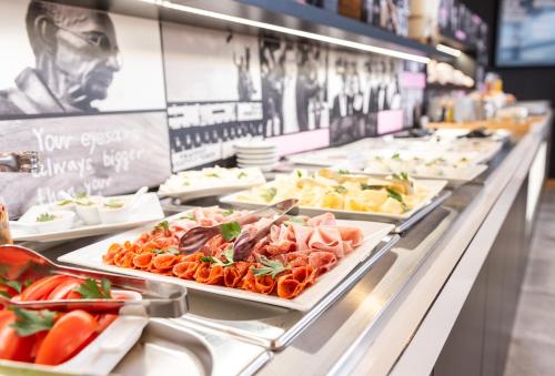 una línea de buffet con platos de comida a la vista en Hotel Troja, en Praga