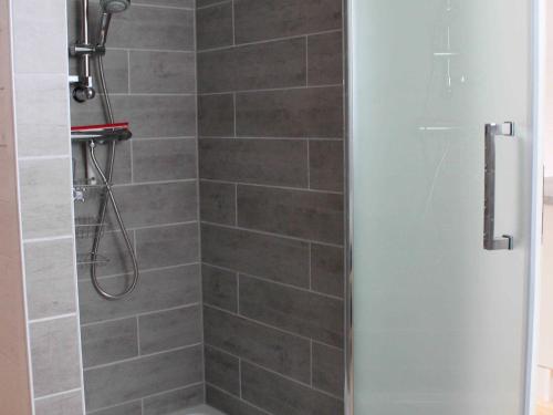 a shower with a glass door in a bathroom at Finnhütte in Kröslin in Kröslin