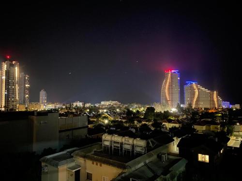 a view of a city at night with tall buildings at Great Views Apartment II in Limassol