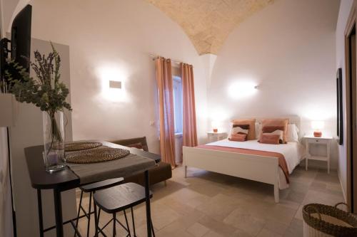 a bedroom with a bed and a table and a table sidx sidx sidx at IMMA APULIA APARTMENTS in Bari