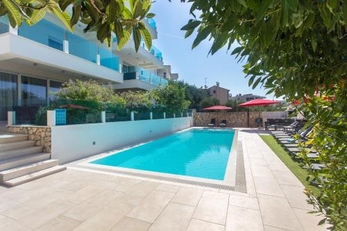 a swimming pool in front of a building at Villa Aqua in Zaboric