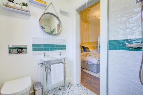 a bathroom with a sink and a mirror at 132 Qweens Stay in Southend-on-Sea