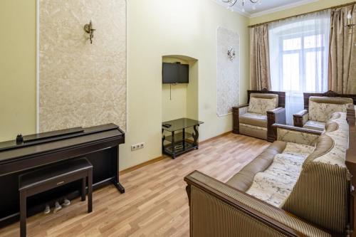 a living room with a couch and a piano at Romari Лесі Українки in Lviv