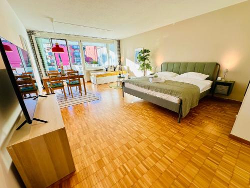 a bedroom with a bed and a table and chairs at New Studio with Sunny Terrace & Air Condition in Zürich
