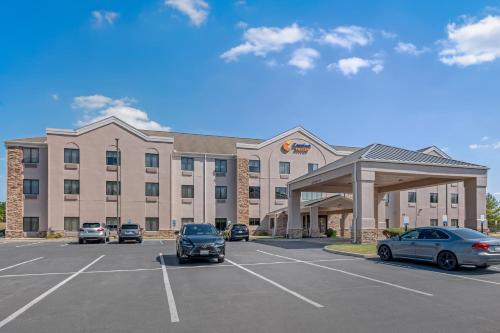 a large building with cars parked in a parking lot at Comfort Suites West Indianapolis - Brownsburg in Brownsburg