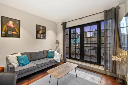 a living room with a couch and a table at 2 Bed Lux Apartments near Central London FREE WIFI by City Stay Aparts London in London