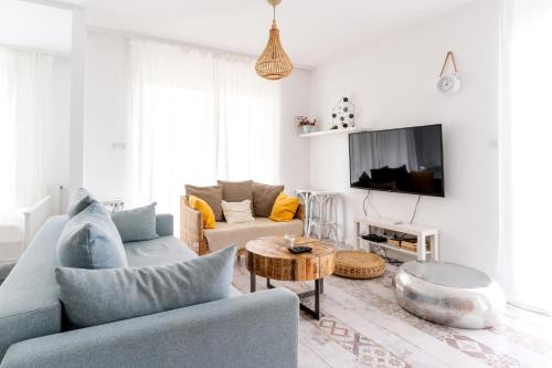 a living room with a couch and a tv at Randez-View - 60 m2, widok na jezioro z tarasu, duży taras, klima, parking, Netflix in Iława