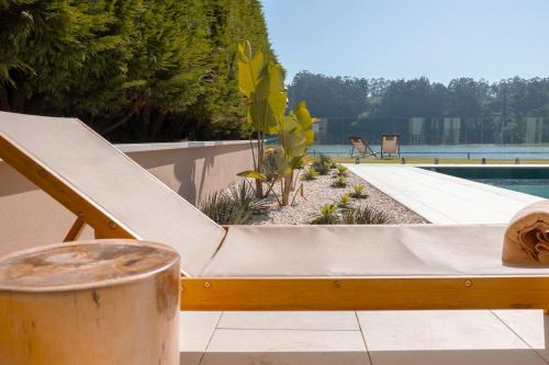 a slide next to a swimming pool with a swimming pool at Malates Slow Boutique Hotel in Foz